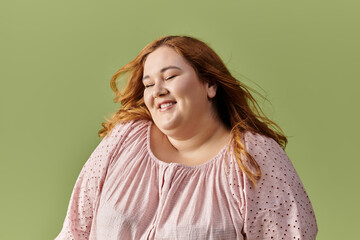 Fototapeta premium A woman with long red hair smiles brightly.