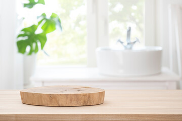 Wooden table with pedestal for product display on blurred bathroom window and sink background