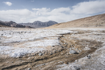 Panoramic landscape of textured Tien Shan mountains in Pamir in Tajikistan, panoramic landscape of a mountain range with snow and glaciers in summer