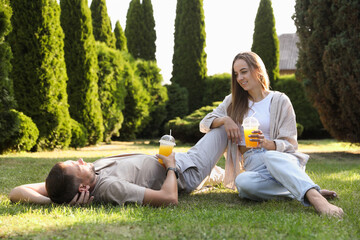 Obraz premium Couple spending time together on green lawn in park