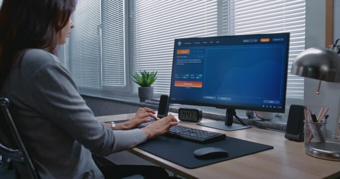 Adult woman types prompt in AI video generator on computer. PC screen shows artificial intelligence chatbot generating detailed high-quality video of Jupiter and its moon. Machine learning concept.