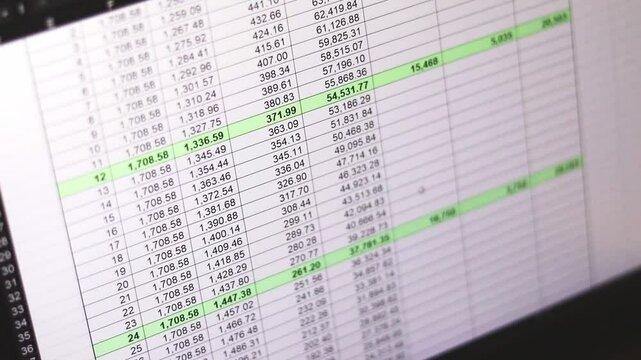 Footage of an dark mode excel sheet scrolled on computer screen showing bank loan amortization table. Banking