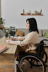 A woman in a wheelchair sits at a table, writing on a piece of paper.