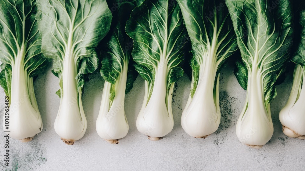 Wall mural A row of fresh bok choy arranged neatly, showcasing its vibrant green leaves and white stems.