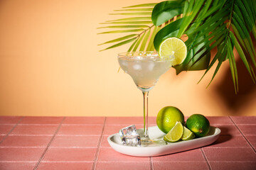 Margarita, traditional alcoholic cocktail with lime, silver tequila, ice cubes and sea salt. Pink...