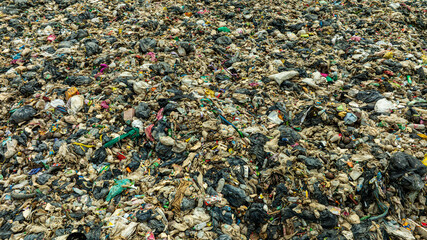 Top view trash, plastic cups and plastic bags at the beach. environmental problem concept and...