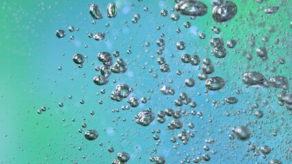 Freeze Motion Shot of Moving Bubbles on Green and Blue Background