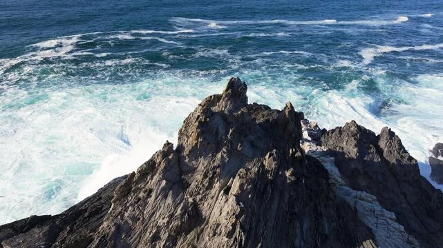 Sharp Rough Stones On The Rocky Shoreline Of Seixo Branco, near Oleiros, A Coruna Province, Galicia, Spain. Aerial Descending Shot
