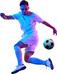 Focused football player, in training session, works on controlling ball against transparent background demonstrating precision and athleticism. Concept of championship, sport events, final game. Ad