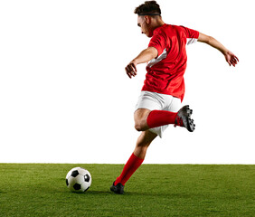 Focused sportsman, dressed in red and white, performing dynamic strike on ball during football...