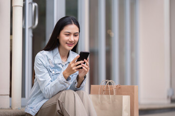 Happy Shopper Relaxing with Smartphone After Black Friday Shopping Spree