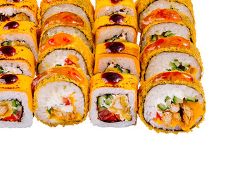 Sushi set covered with sauce and sesame seeds on white background