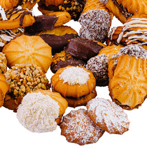 Pile of shortbread cookies with chocolate and nuts on white background