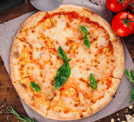 Delicious pizza margherita lying on wooden table