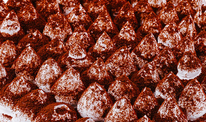 Tiramisu cake surface covered in cocoa powder forming a pattern