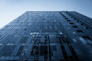 Modern Architectural Design Showcasing Glass Facade and Urban Reflection