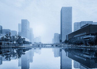 Fototapeta premium Serene Urban Cityscape With Reflective Water at Dusk