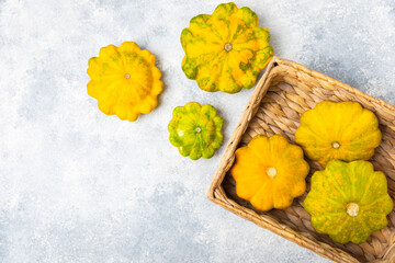 Pattypan zucchini on a textured kitchen table. squash. Fresh organic pattypan squashes on...