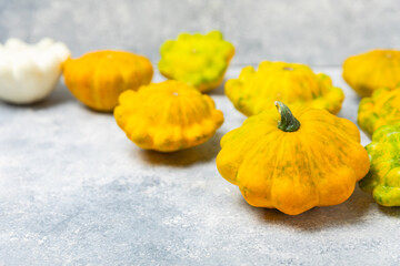 Pattypan zucchini on a textured kitchen table. squash. Fresh organic pattypan squashes on...
