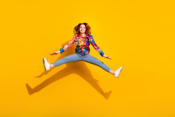 Full size photo of optimistic positive girl dressed print shirt jeans jumping announcing black...