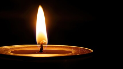 Bright Flame from Candle in Dark Surroundings