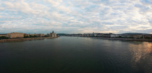 Fototapeta premium Sunset clouds over Danube river in Budapest, Hungary parliament building visible on left side