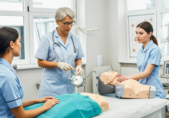 Medical training session with nurses practicing cpr on mannequins in a hospital setting