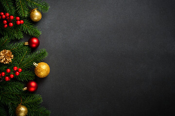 Black christmas flat lay background. Christmas tree with holidays decorations at black background.