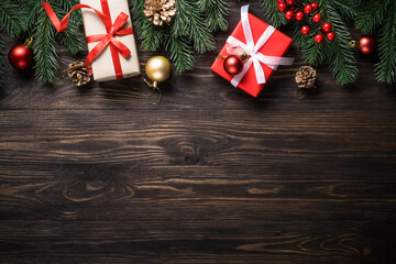 Christmas presents and holiday decorations on wooden background. Flat lay image.