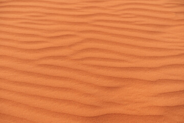 Desert patterns of wind-sculpted sand dunes in Wadi Ram located in the Sahara during sunsets warm glow