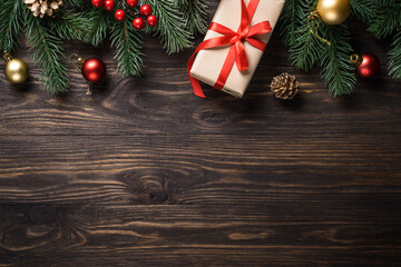 Christmas presents and holiday decorations on wooden background. Flat lay image.