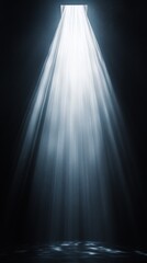Bright light shining through square opening in dark room