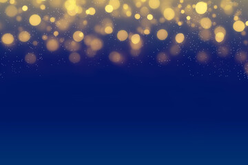Christmas lights on blue night background with golden bokeh. Defocused golden light dots against dark blue background
