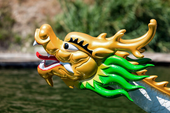 Golden dragon head figurehead adorning traditional wooden boat