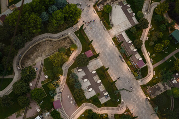 Top view of a beautiful landscaped park during sunset with winding paths and gathering places