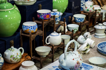 A Colorful Display of Traditional Ceramic Teapots and Bowls