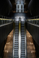 Fototapeta premium Strict geometry of empty metal escalators at a metro station.