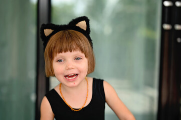 Kid girl in costume of black cat