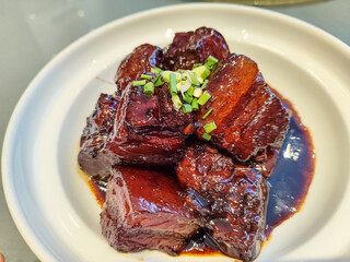 Delicious Braised Pork with Savory Sauce and Fresh Herbs