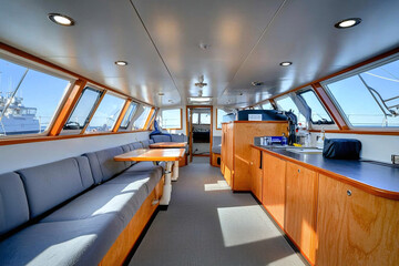 Fototapeta premium a small yacht's interior cabin being tidied, muted nautical colors