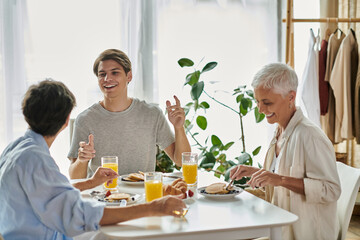 A loving LGBTQ family enjoys breakfast together, filled with laughter and warmth in a cozy space.