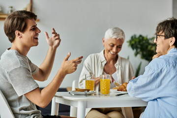 A joyful LGBTQ family shares laughter and delicious breakfast in a sunny kitchen.