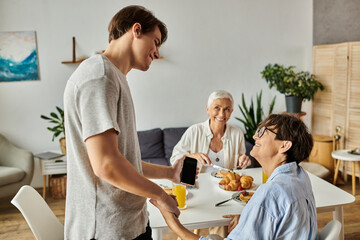 A loving LGBTQ family enjoys breakfast, sharing smiles and conversation around the dining table.