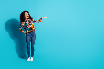 Photo of lovely cute woman wear trendy clothes demonstrate empty space isolated on blue color background