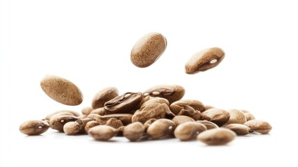 A collection of brown coffee beans, some floating above a pile, showcasing their texture.