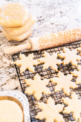 Cooling Snowflake-Shaped Sugar Cookies on a Rack