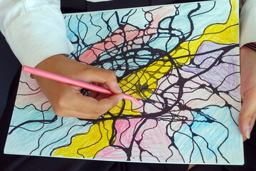 Close-up drawings of neurographica. Method of metamodern art and psychological studies of neurographics. Abstract neurographic drawing with a marker, colored pencils. neurographics concept.
