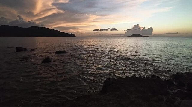 hd video of sunset sky and sea waves near cluny beach in sainte rose with Kahouanne island in the background