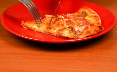 Cutting pizza slice on plate, close up view. Tasty food at pizzeria. Concept of takeaway. Fast food order. Restaurant advertising. Delicious cheesy pizza. Pizza. Unhealthy food. Junk food. Fatty food.