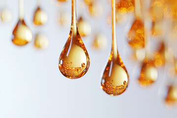 Close up of golden oil drops suspended, showcasing their clarity and texture. shimmering droplets create captivating visual effect, evoking sense of luxury and purity